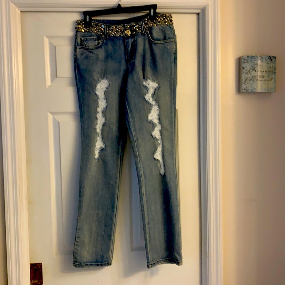 A pair of jeans with an ornate waist.